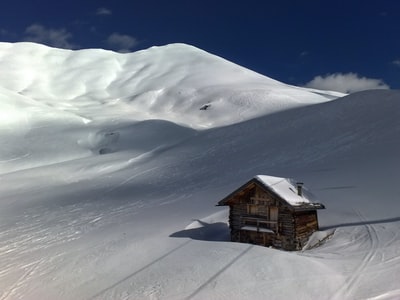 棕色的木头房子在冰雪覆盖的土地的中心
